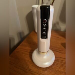 White Skincare Tool with Gold Accents